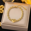 Gold-plated heart charm link bracelet made of stainless steel on a jewelry box display - Gold