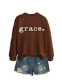 Detail of coffee brown sweatshirt featuring white grace text and heart graphic print - Coffee Sweatshirt (White Font)