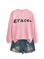 Detail of pink crewneck sweatshirt with grace print and distressed denim shorts - Pink Sweatshirt (Black Font)