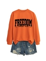 Detail of orange Freedom sweatshirt with black typography and distressed denim shorts - Orange Sweatshirt (Black Font)