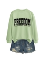 Detail of light green sweatshirt with Freedom Charlie Kirk print and denim shorts - Olive Green Sweatshirt (Black Font)