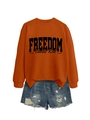 Close-up of caramel orange crewneck sweatshirt with black FREEDOM lettering and denim shorts - Burnt Orange (Black Font)