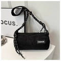 Detail of black corduroy barrel bag with fashion label and braided rope shoulder strap - Black