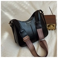 Close-up of black retro crescent bag featuring a vintage ethnic pattern wide shoulder strap - Black