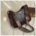 Detail of vintage brown shoulder bag with textured jacquard strap and gold hardware - Brown