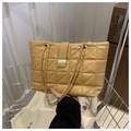 Detail of light brown quilted leather tote with gold chain strap and metallic buckle closure - Khaki