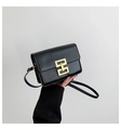Matte black flap crossbody bag with bright gold square buckle and slim shoulder strap - Black