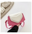 Detail of pink and beige heart handbag with gold hardware on soft fabric background - Pink