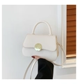 Chic cream white crossbody bag with round gold buckle and minimalist leather finish - Off White