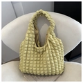 Macro view of a soft yellow popcorn texture tote bag on a minimalist white chair - Yellow