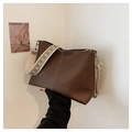 Dark brown pebble leather bucket bag with geometric woven strap and white stitching detail - Brown