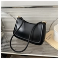 Close-up of a black minimalist underarm bag on a metal stand with a coffee cup - Black