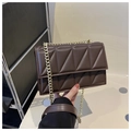 Close-up of dark brown chain crossbody bag with geometric quilted pattern detail - Brown