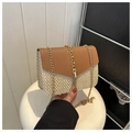 Detail of woven straw crossbody bag with leather flap, metal chain and decorative tassel - Brown