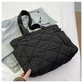 Close-up of black quilted nylon fabric and diamond stitching on large tote bag - Black