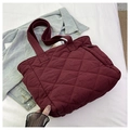 Close-up of wine red quilted nylon tote bag with rhombus patterns and soft texture - Burgundy