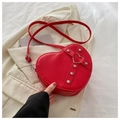 Red heart-shaped crossbody bag featuring silver stud details and a metal heart buckle - Red