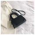 Minimalist black leather handbag for women featuring a smooth finish and sleek shoulder strap - Black