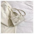 Elegant cream white crossbody bag with bow accents and round top handles - White