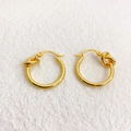 Detail of gold-plated hoop earrings featuring a stylish knot design and high-polish finish - Gold