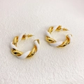 Golden double-line twisted C-shaped hoop earrings with white enamel finish on a textured background - White
