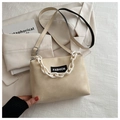 Detail of beige leather crossbody bag with chunky white chain and FASHION letter label - Khaki