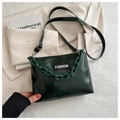 Detail of forest green glossy leather crossbody bag with chunky resin chain and fashion label - Green