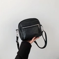 Minimalist black PU leather crossbody bag with adjustable strap and front pocket - Black