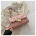 Elegant pink quilted chain bag with gold circular buckle on white blazer background - Pink