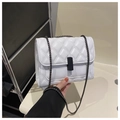 Detailed view of white quilted crossbody bag with black chain strap and metal clasp - White