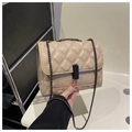 Detail of beige quilted flap bag with dark metal chain and rectangular black lock closure - Khaki