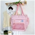 Pinkfarbene Nylontasche mit Netz-Vordertasche und bunten Sternen am Holzkleiderbügel - Rosa