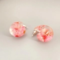 Macro detail of resin hoop earrings with real pink dried flowers and S925 silver posts - Pink