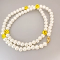 Elegant pearl necklace with yellow smiley face charms and a gold lobster clasp - White (Yellow Smiley Face)