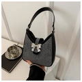 Close-up of black shoulder bag with silver rhinestones and metal bow buckle detail - Black