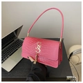 Macro view of rose pink crocodile pattern texture and golden tassel buckle on bag - Pink