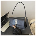 Detail of black crocodile texture bag featuring gold metal logo and tassel decoration - Black