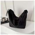 Detail of black canvas tote bag with drawstring pleated edges and minimalist strap - Black