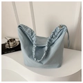 Close-up of light blue nylon tote bag featuring ruched handle detail in minimalist setting - Blue