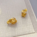 Elegant gold-plated leaf earrings with sparkling cubic zirconia on a beige tray - Gold