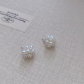 Floral cluster pearl stud earrings with crystal center on beige woven texture - Silver