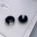 Close-up of handmade ethnic drum earrings with colorful yarn and silver bead trim - Midnight Black