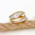 Detail of adjustable 18k gold plated ring with white enamel marble pattern on wavy band - White Marble Texture Wave Style / White