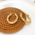Detailed close-up of 18K gold plated brass hoop earrings with natural bamboo texture - Bamboo Earrings