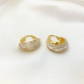 Elegant 18K gold-plated irregular enamel hoop earrings on white silk fabric background - White