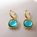 Detail of gold drop earrings featuring square translucent turquoise green gemstones - Blue