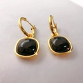 Detailed macro view of vintage gold earrings with deep brown square resin pendants - Black