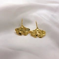 Makroaufnahme vergoldeter Ginkgoblatt-Ohrringe mit Hammerschlag-Textur auf weißer Seide - 18K Gold