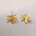Detailed view of 18K gold plated leaf earrings with handmade hammered texture surface - Maple Leaf Style 1