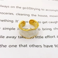 Macro detail of wave edge gold ring with white enamel inlay and adjustable band - White